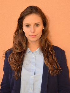 a woman with long hair wearing a blue blazer and white shirt