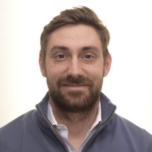 a man with a beard smiling