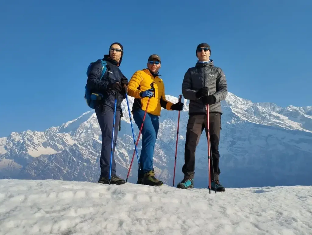 a group of people standing on a snowy mountain